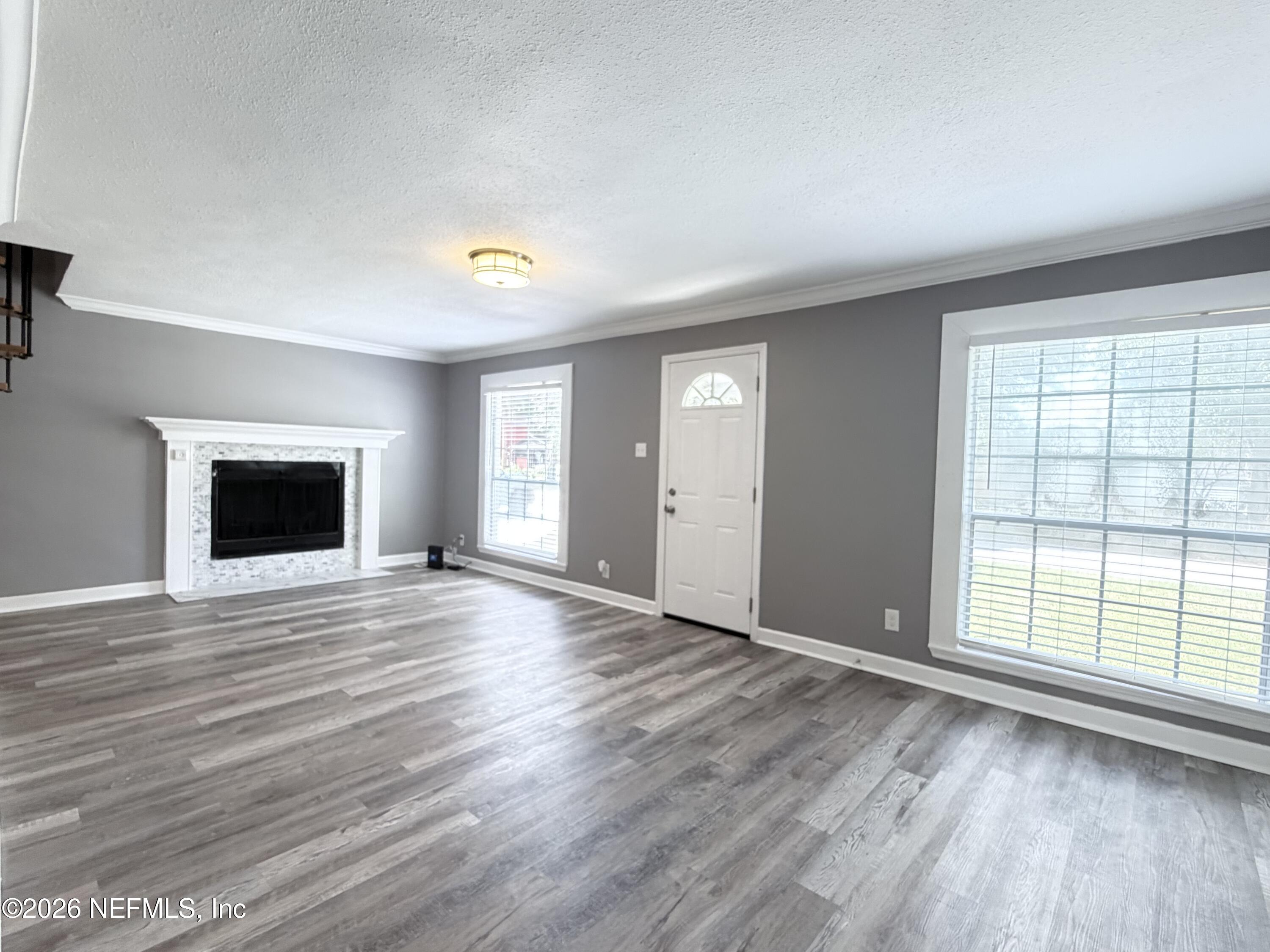 5336 Cruz Road Jacksonville, FL 32207 - Photo 3 of 29 a view of an empty room with wooden floor and a window