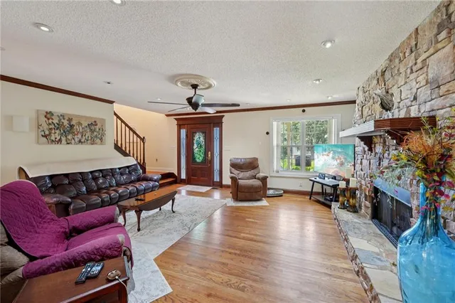 a dining room with furniture a chandelier and wooden floor