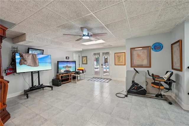 an aerial view of a residential houses with outdoor space and trees