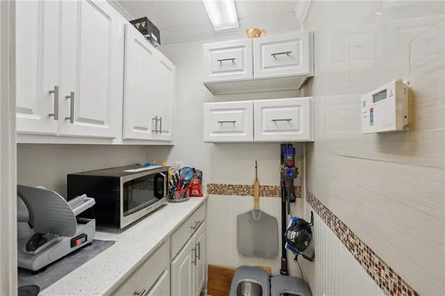 a view of a house with swimming pool and sitting area