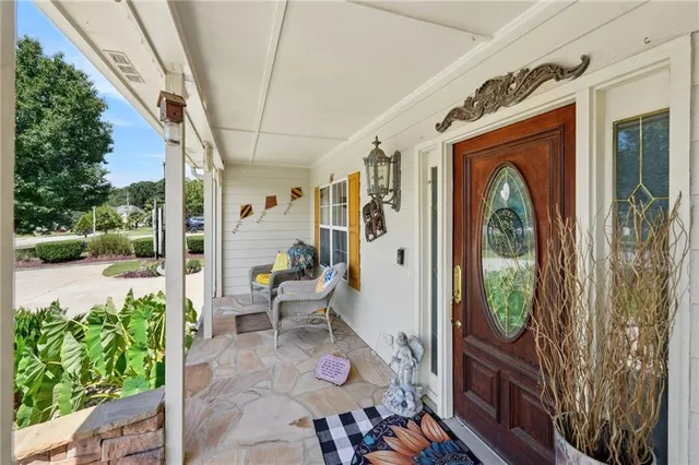 a living room with furniture fireplace and a large window