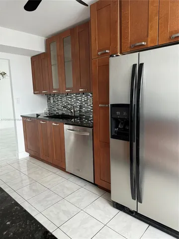 a kitchen with stainless steel appliances a refrigerator and cabinets