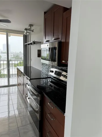 a kitchen with stainless steel appliances a stove microwave and cabinets