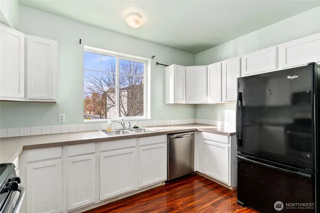 a kitchen with a sink stainless steel appliances and cabinets