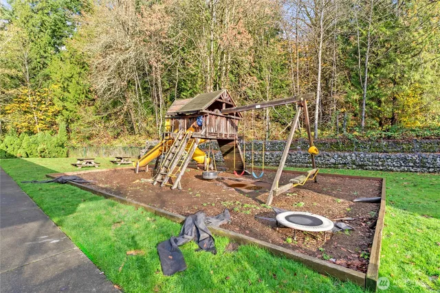 a view of a backyard with swimming pool