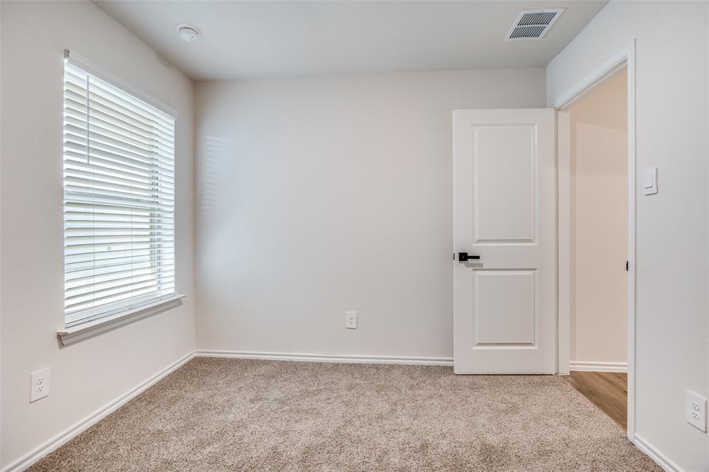 803 Sunlight Loop Princeton, TX 75407 - Photo 11 of 16 an empty room with windows