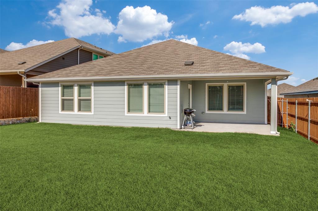 803 Sunlight Loop Princeton, TX 75407 - Photo 15 of 16 a front view of a house with a garden