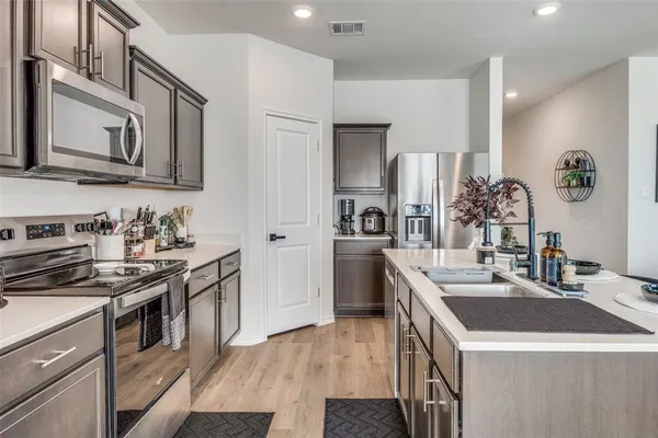 a kitchen with a sink stove and cabinets