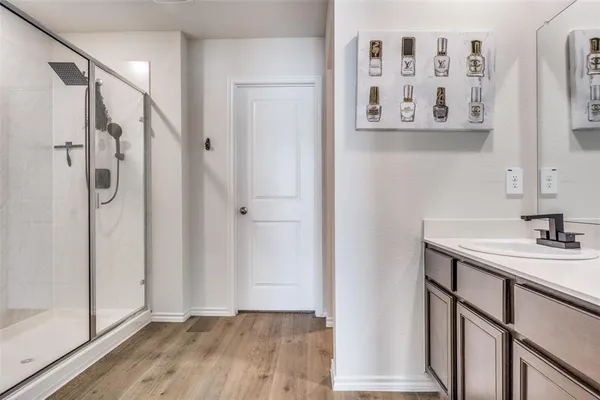 a bathroom with a shower and a sink