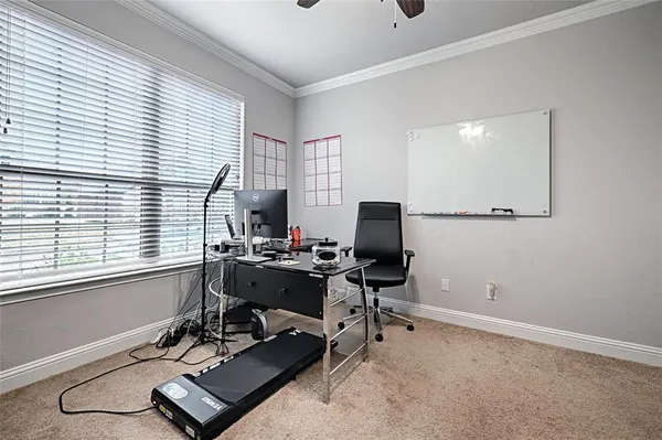 a view of a workspace with furniture and a window