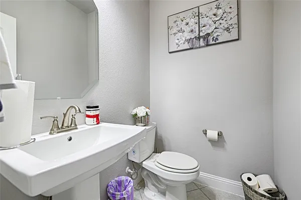 a bathroom with a sink mirror and toilet