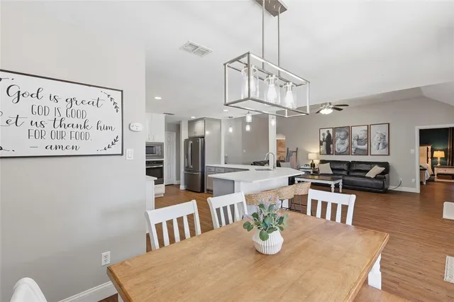 a kitchen with white cabinets stainless steel appliances and sink
