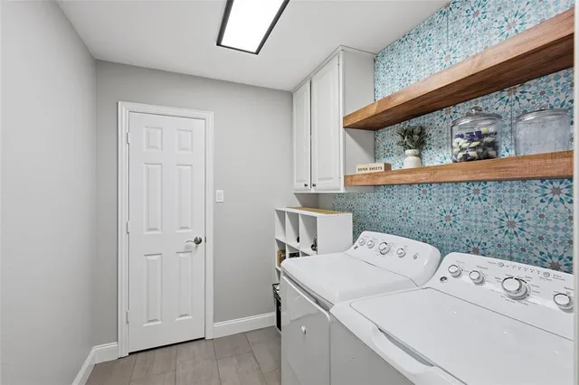 a view of a dining room with furniture wooden floor and a chandelier
