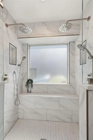 a bathroom with a double vanity sink mirror and shower