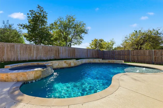 a view of a backyard with swimming pool