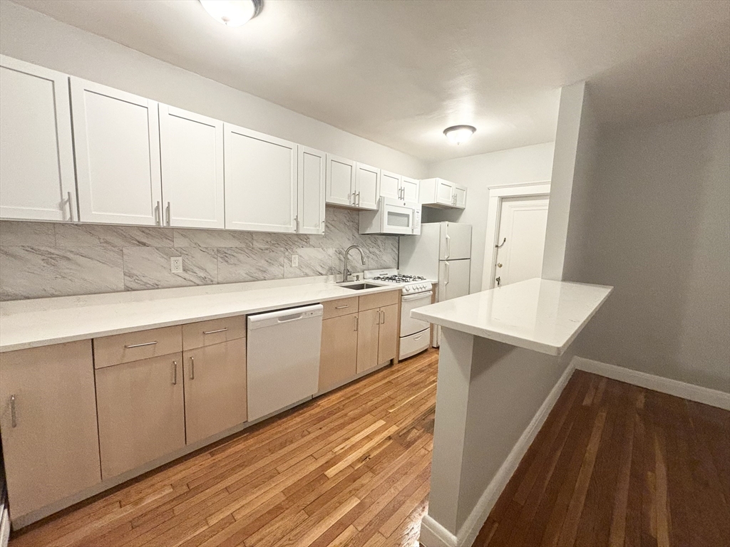 15 Ives Street, Unit 6 Beverly, MA 01915 - Photo 1 of 11 a kitchen with a sink window and cabinets
