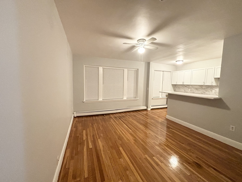 15 Ives Street, Unit 6 Beverly, MA 01915 - Photo 2 of 11 a view of an empty room with window and wooden floor