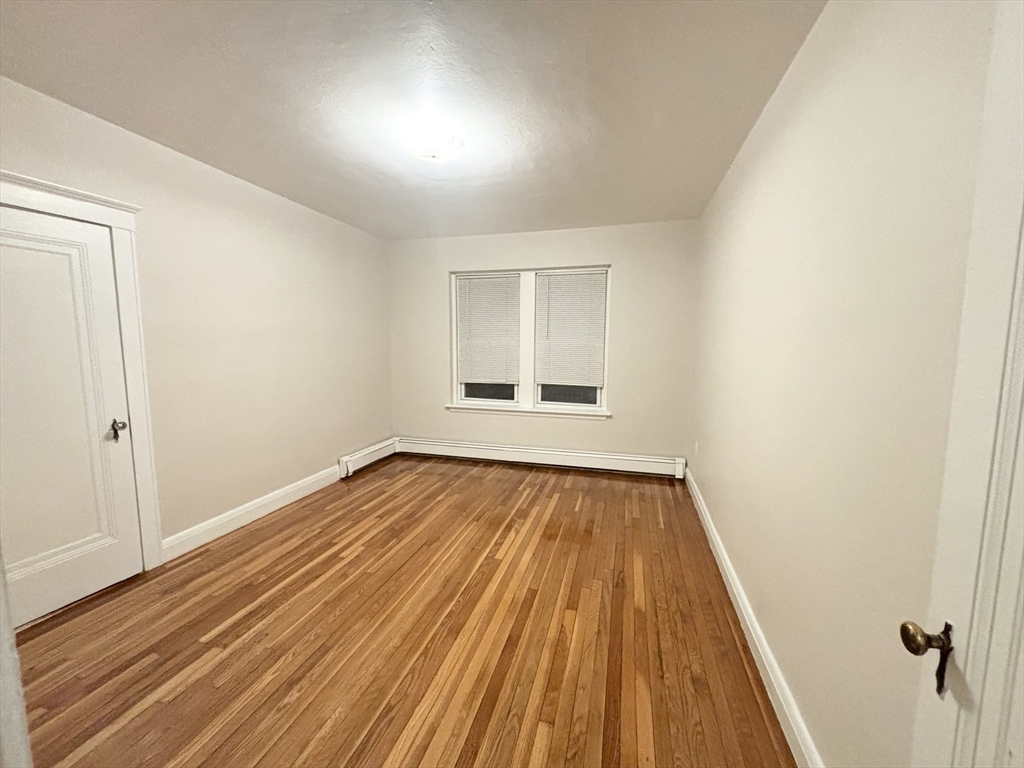 15 Ives Street, Unit 6 Beverly, MA 01915 - Photo 5 of 11 wooden floor in an empty room with a window