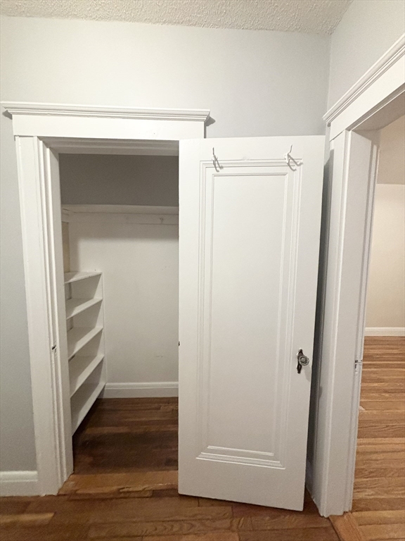 15 Ives Street, Unit 6 Beverly, MA 01915 - Photo 9 of 11 a view of walk in closet with wooden floor