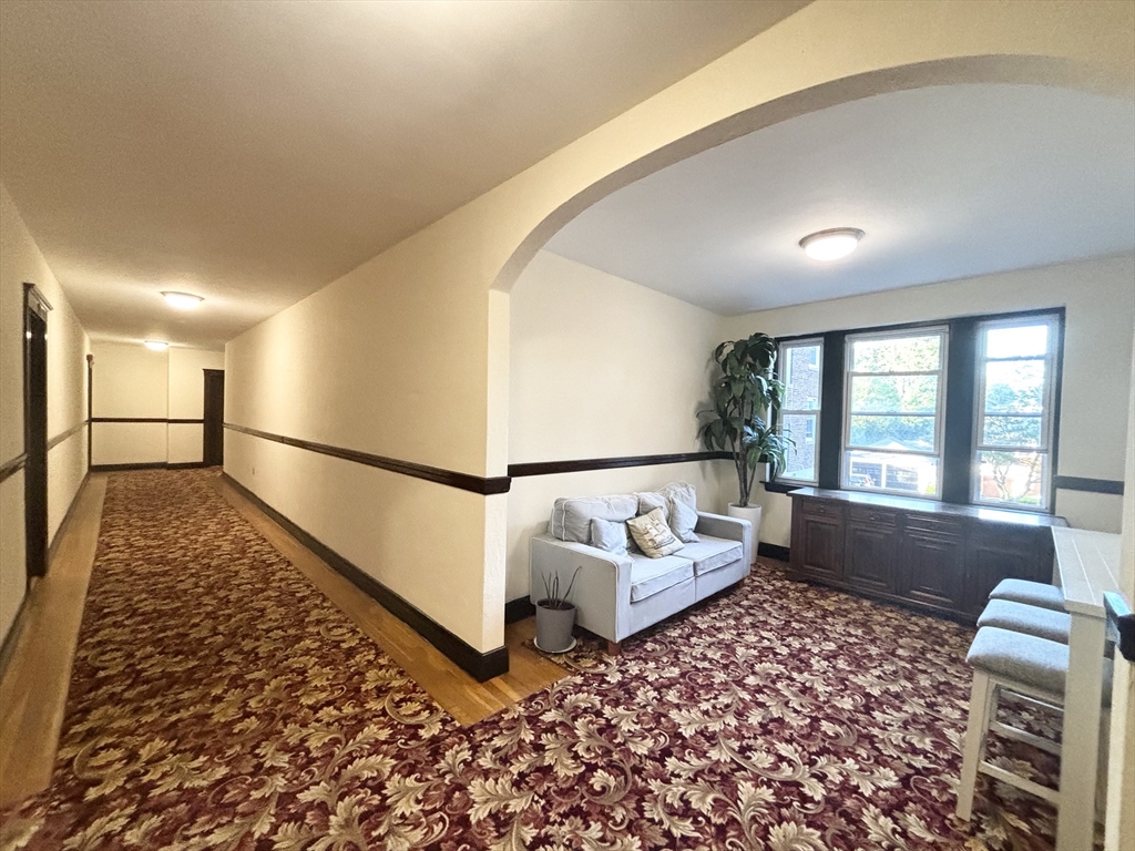 15 Ives Street, Unit 6 Beverly, MA 01915 - Photo 10 of 11 a living room with a couch and a rug