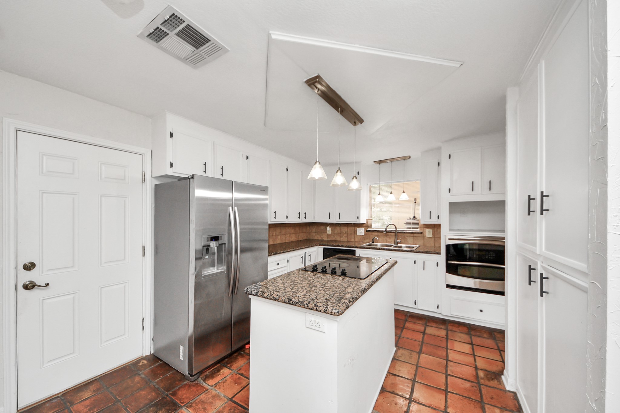 6706 Trebeck Lane Spring, TX 77379 - Photo 11 of 46 a kitchen with a refrigerator a sink and cabinets