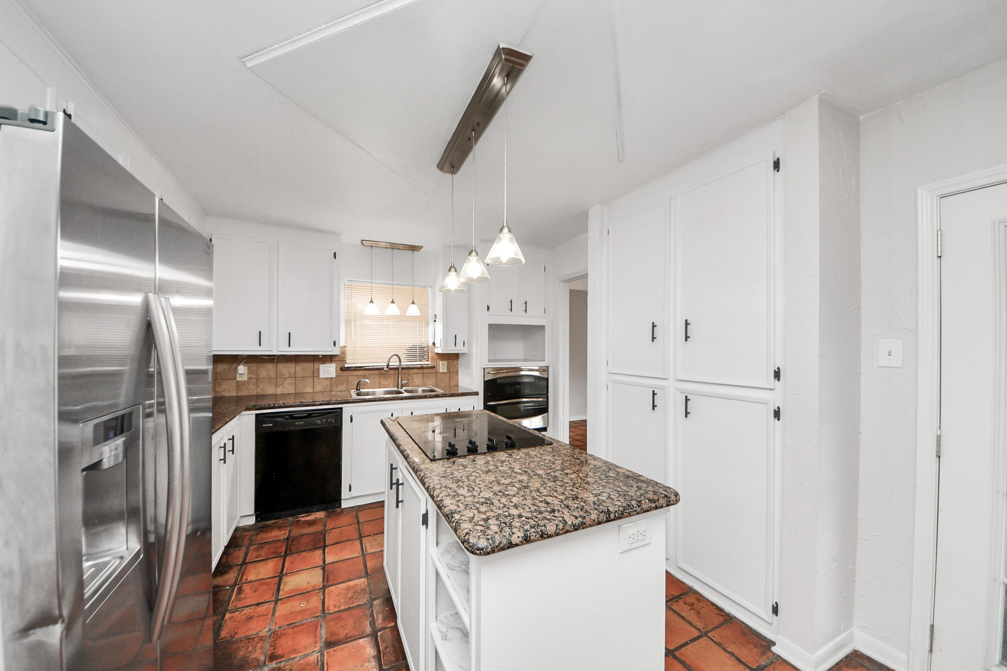 6706 Trebeck Lane Spring, TX 77379 - Photo 13 of 46 a kitchen with stainless steel appliances granite countertop a sink stove and refrigerator