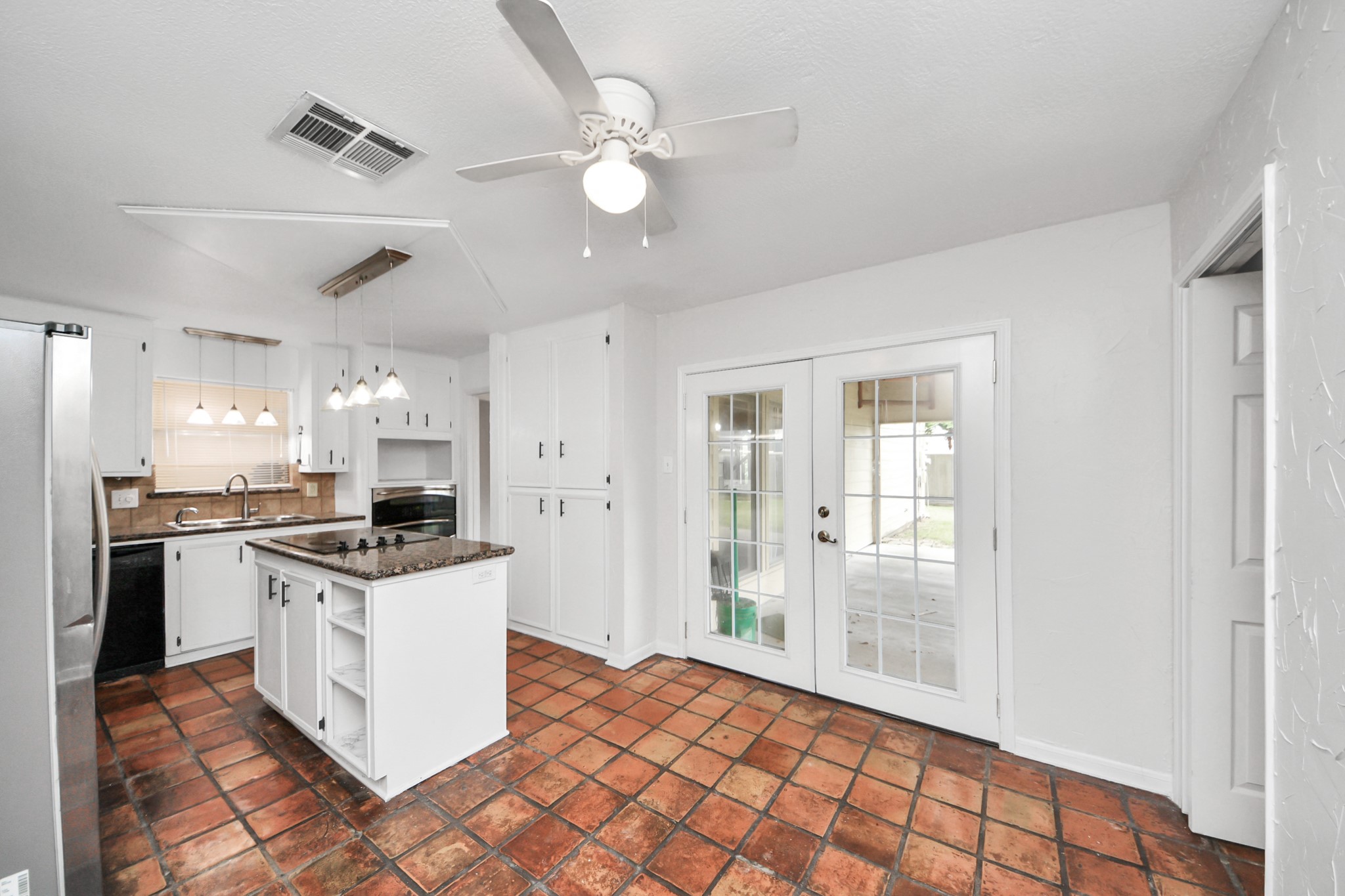 6706 Trebeck Lane Spring, TX 77379 - Photo 16 of 46 a kitchen with stainless steel appliances granite countertop a stove a sink and a refrigerator with white cabinets