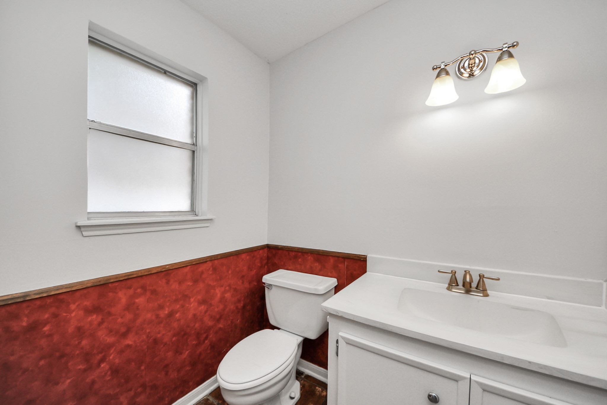 6706 Trebeck Lane Spring, TX 77379 - Photo 18 of 46 a bathroom with a sink a toilet and a window