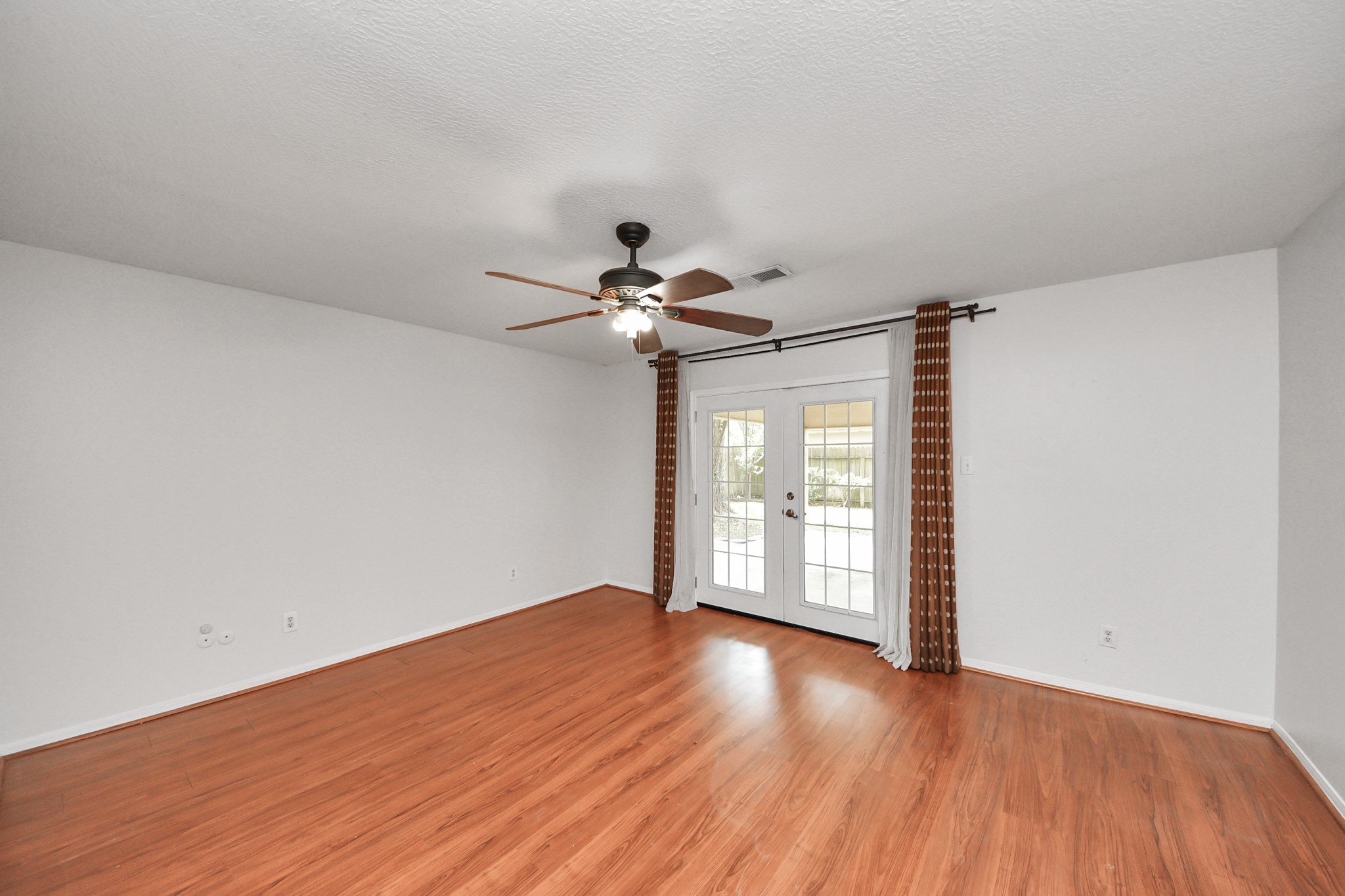 6706 Trebeck Lane Spring, TX 77379 - Photo 27 of 46 a view of empty room with wooden floor and fan