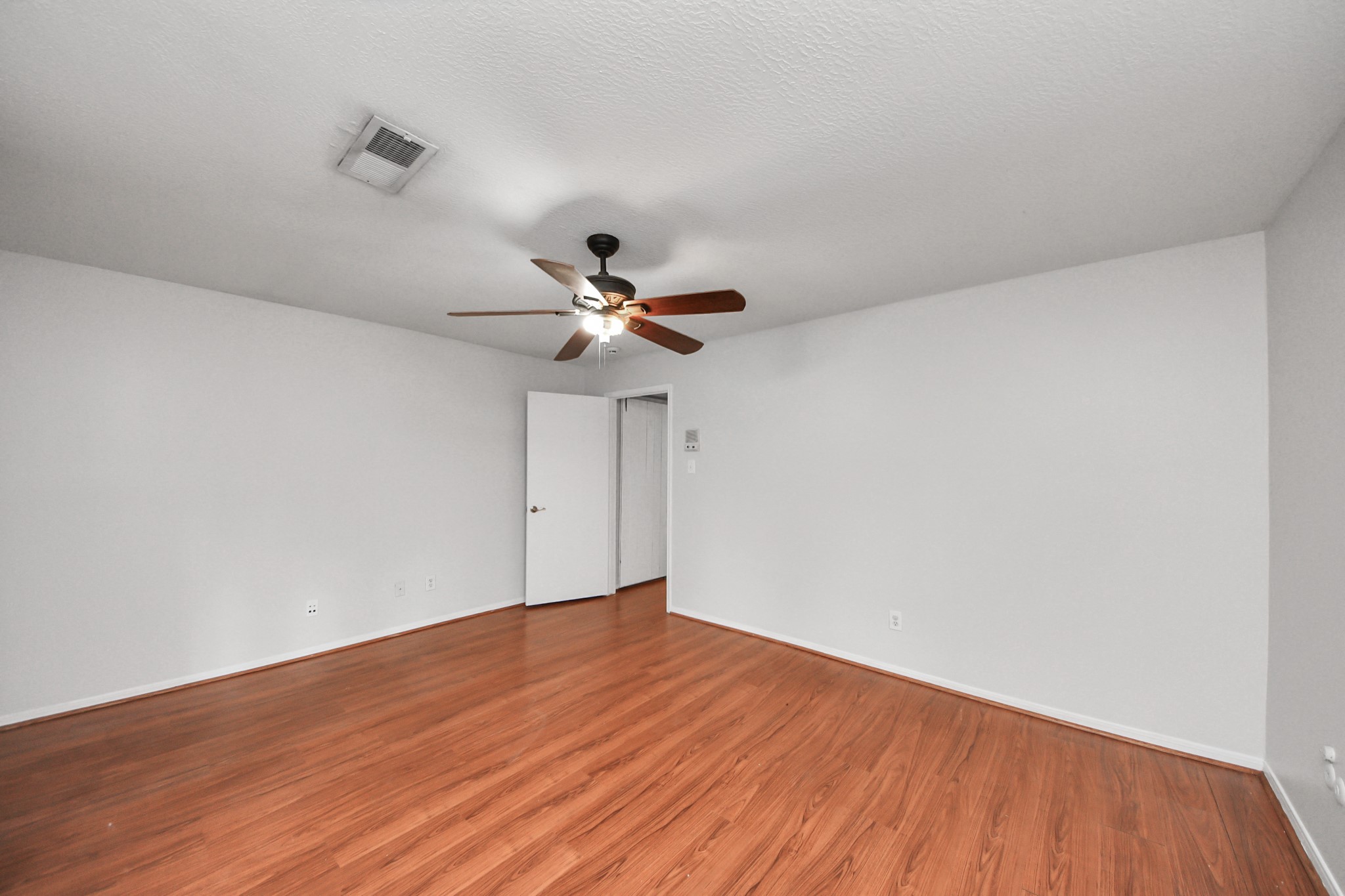 6706 Trebeck Lane Spring, TX 77379 - Photo 28 of 46 a view of an empty room with wooden floor