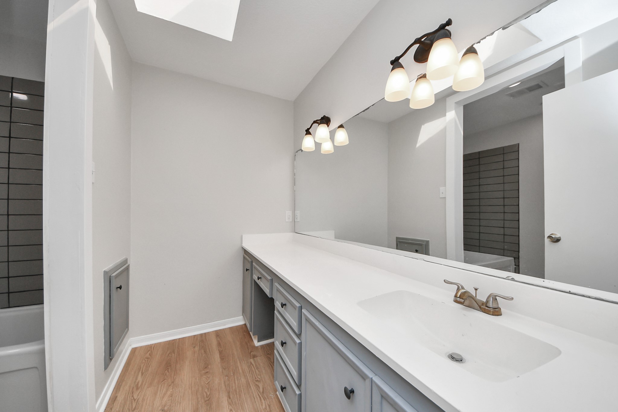 6706 Trebeck Lane Spring, TX 77379 - Photo 33 of 46 a bathroom with a sink vanity and a mirror