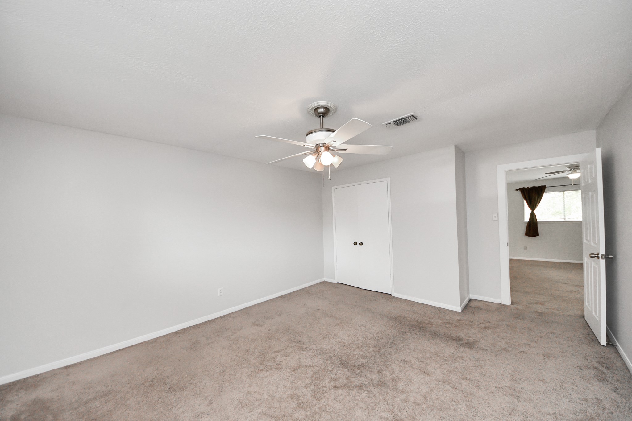 6706 Trebeck Lane Spring, TX 77379 - Photo 39 of 46 a view of an empty room with a ceiling fan