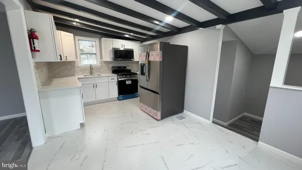 a kitchen with a refrigerator and window