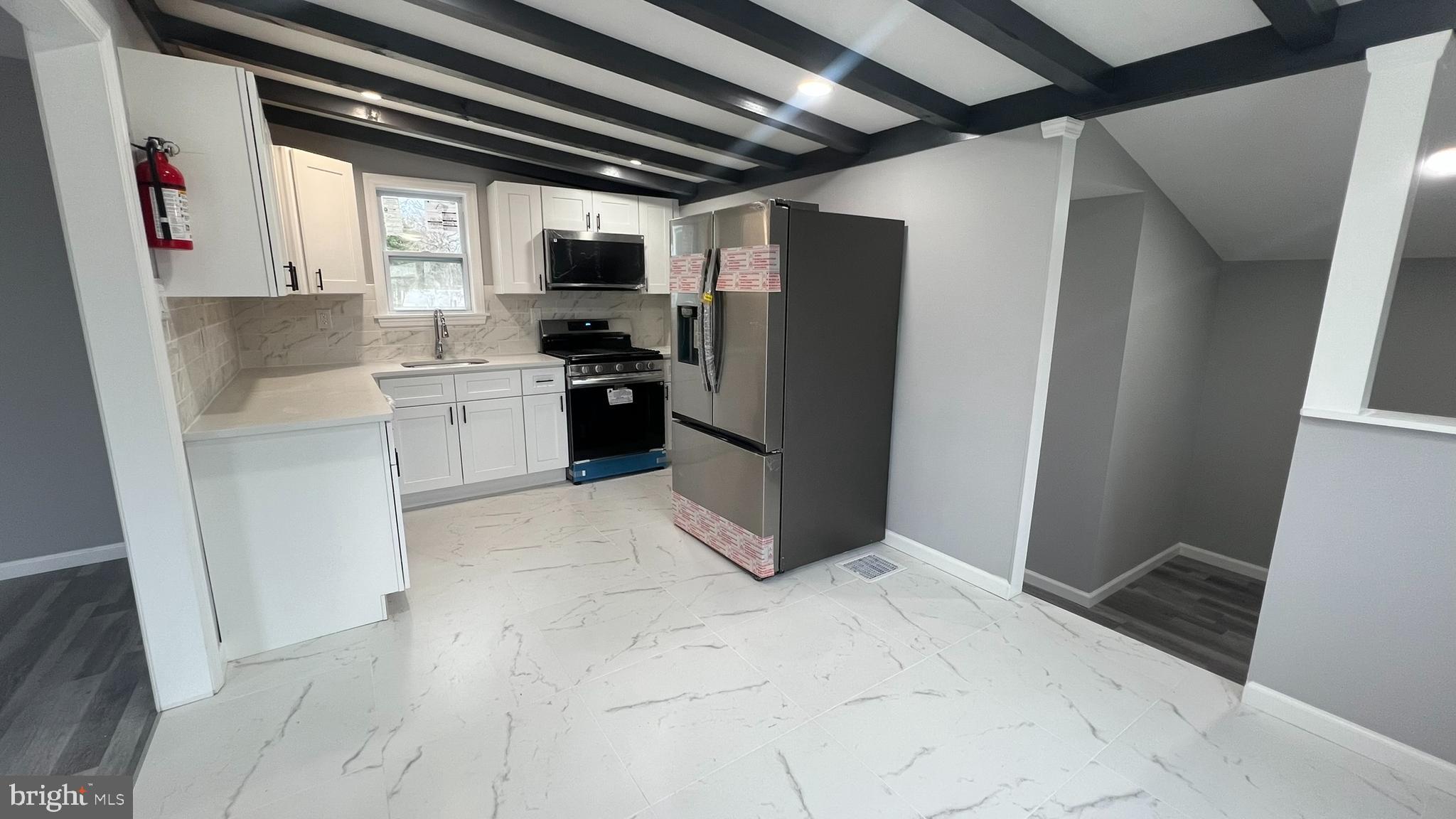434 East Maple Avenue Lindenwold, NJ 08021 - Photo 14 of 36 a kitchen with a refrigerator and window