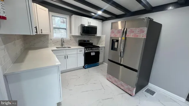 a kitchen with a refrigerator sink and a stove