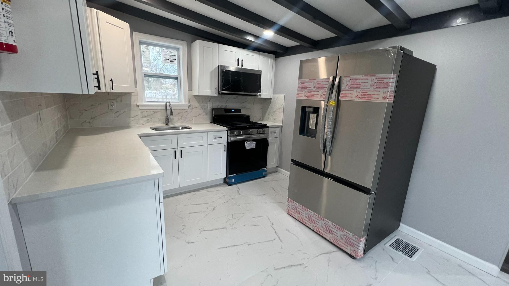 434 East Maple Avenue Lindenwold, NJ 08021 - Photo 15 of 36 a kitchen with a refrigerator sink and a stove