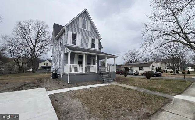 a front view of a house with a yard covered in snow