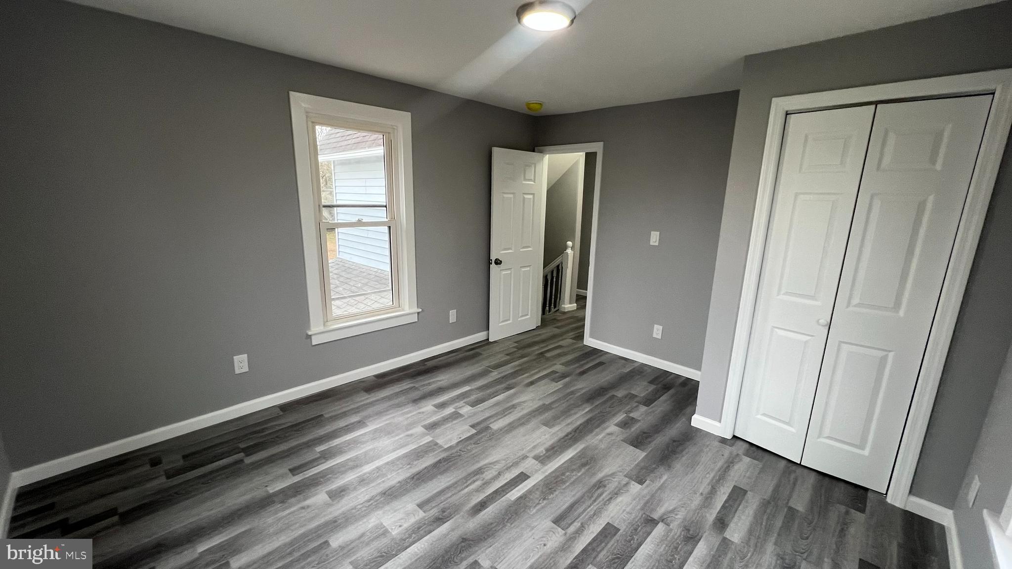 434 East Maple Avenue Lindenwold, NJ 08021 - Photo 28 of 36 a view of an empty room with wooden floor and a window