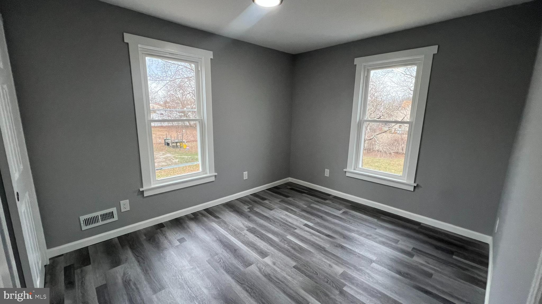 434 East Maple Avenue Lindenwold, NJ 08021 - Photo 31 of 36 an empty room with wooden floor and windows