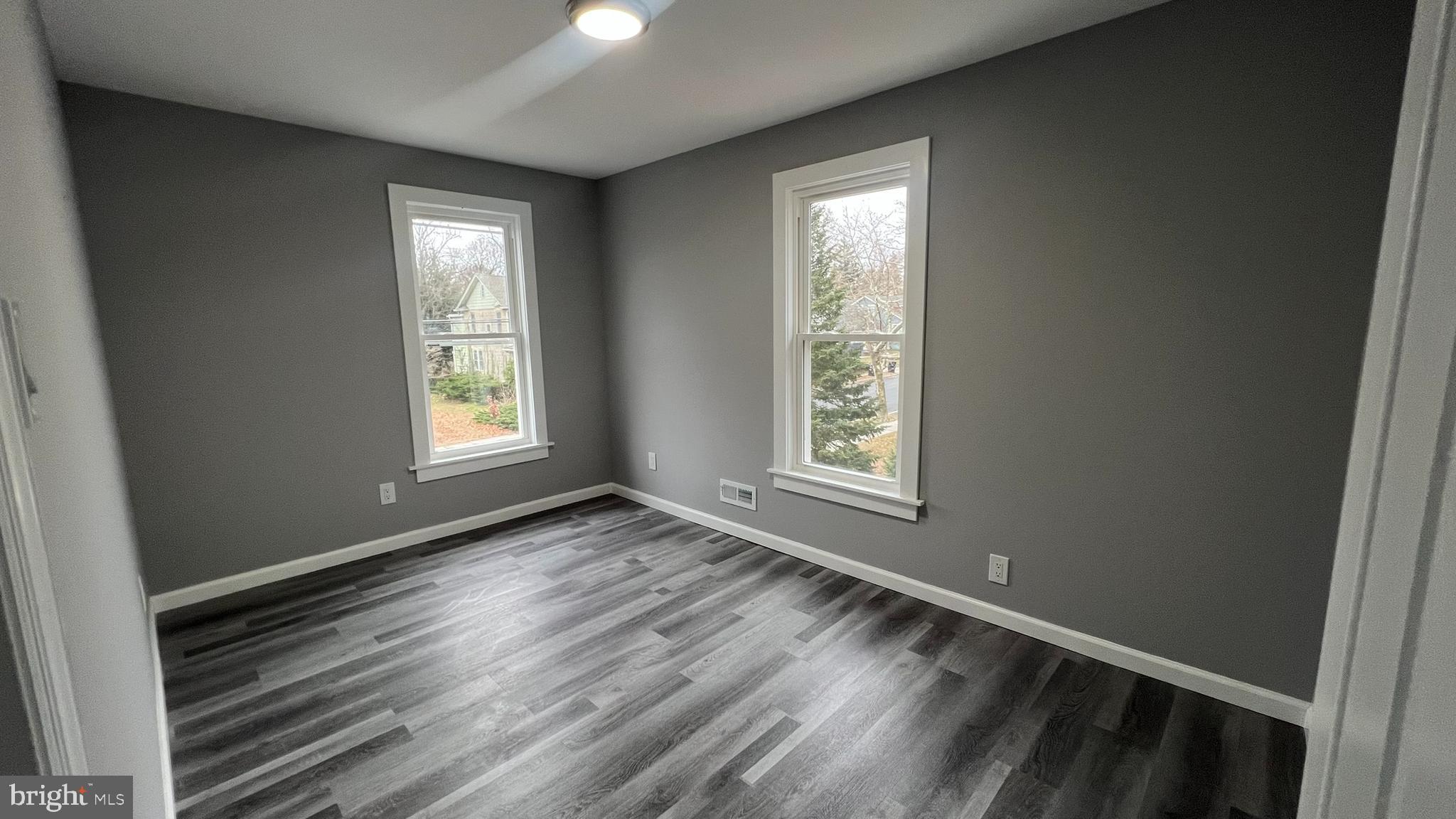 434 East Maple Avenue Lindenwold, NJ 08021 - Photo 33 of 36 an empty room with wooden floor and windows