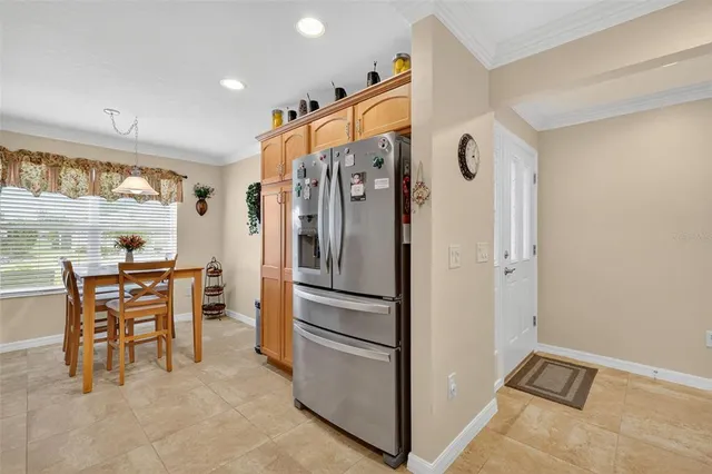 a kitchen with stainless steel appliances granite countertop a refrigerator and a stove top oven