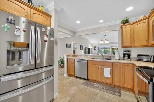 a kitchen with stainless steel appliances granite countertop a refrigerator and a stove top oven