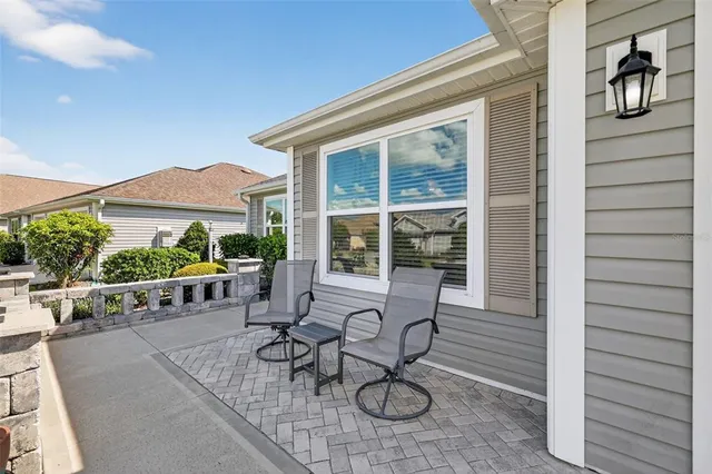 a view of a patio with table and chairs and potted plants