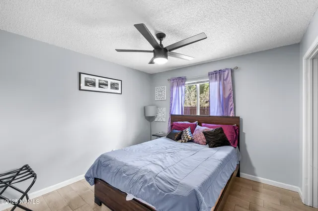 a bedroom with a bed a dresser and a window