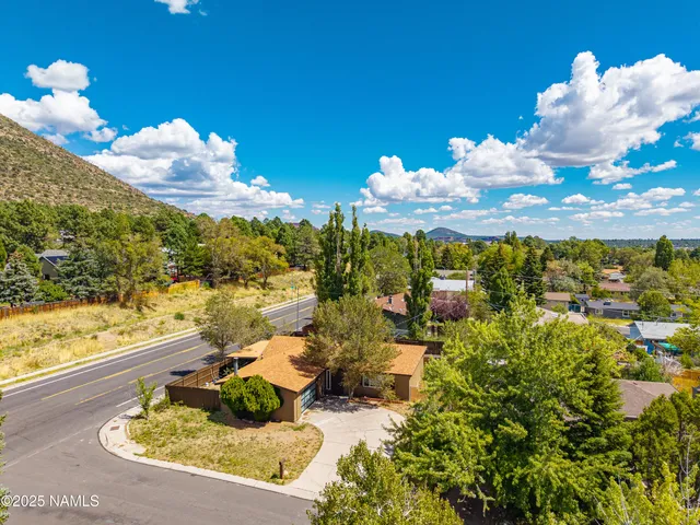 an aerial view of residential houses with outdoor space