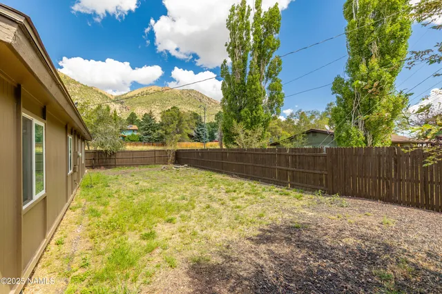 a living room with furniture and a flat screen tv with wooden floor
