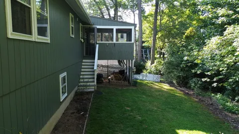 a view of house with a yard