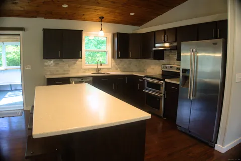 a kitchen with a refrigerator sink and microwave