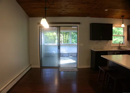 a room with wooden floor and a fireplace