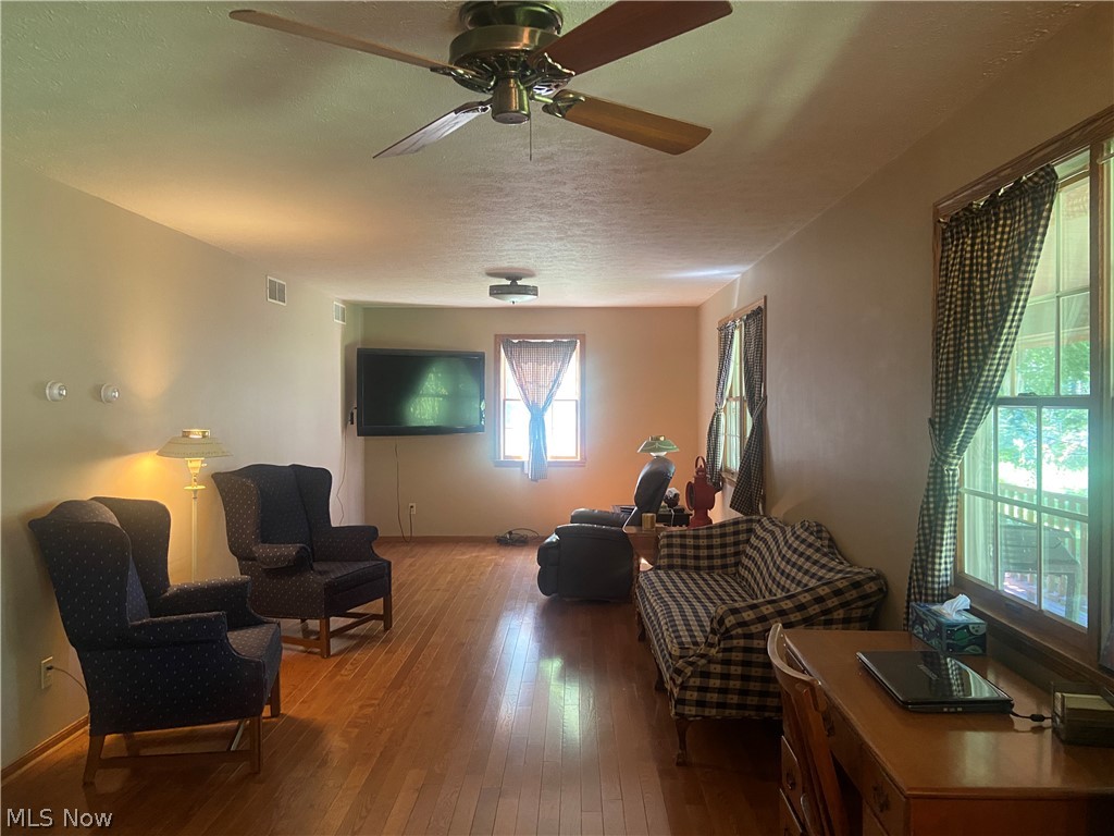 2445 South Elyria Road Wooster, OH 44691 - Photo 14 of 46 Living area featuring hardwood / wood-style flooring, a textured ceiling, and ceiling fan